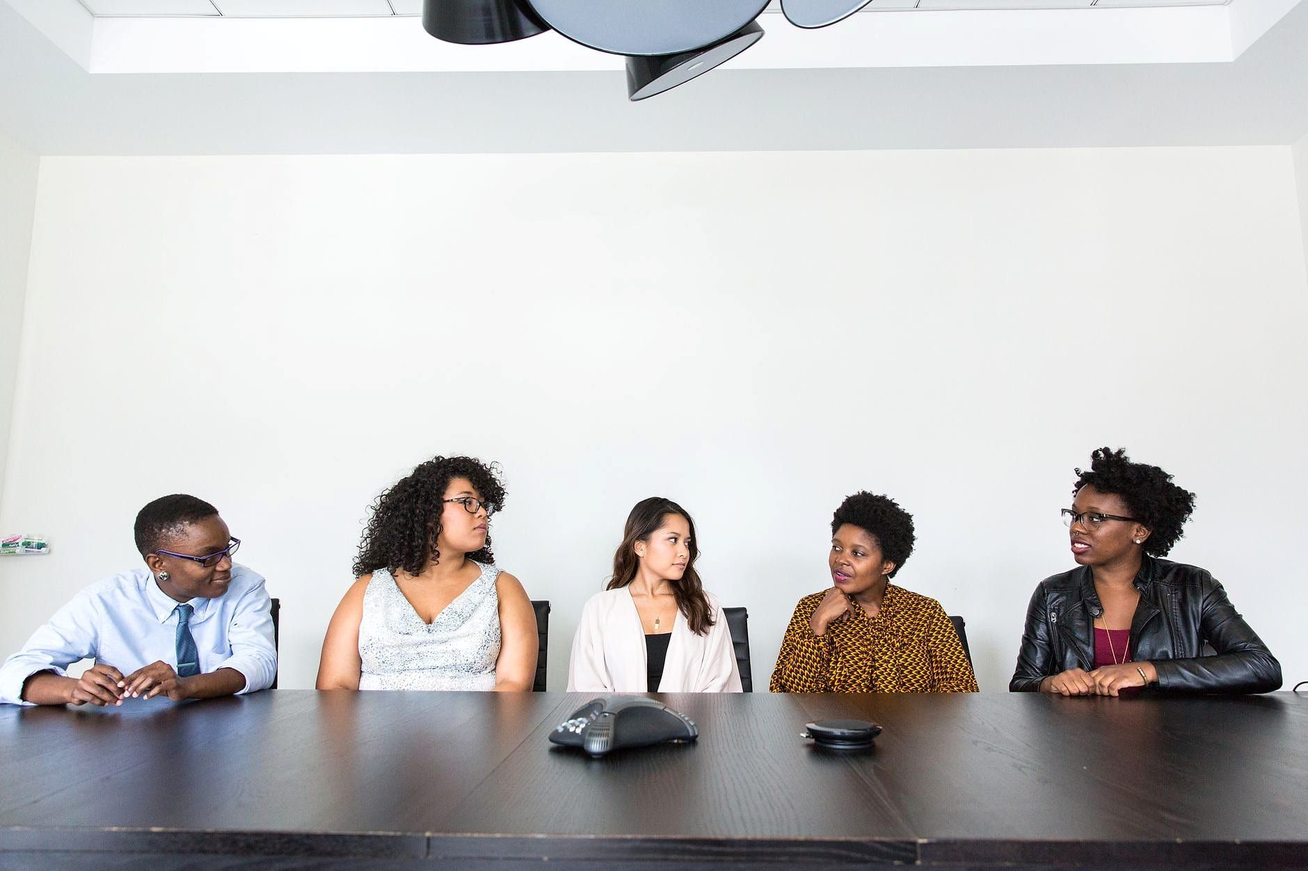 A professional team in a meeting around a table.